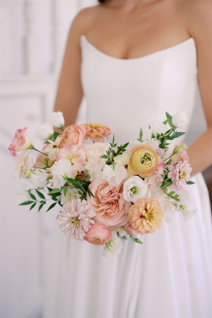 Alt text:
Close-up of a romantic spring bridal bouquet with peach ranunculus and pink garden roses, captured during bridal portraits in the Texas Hill Country with Lila Lane Events.