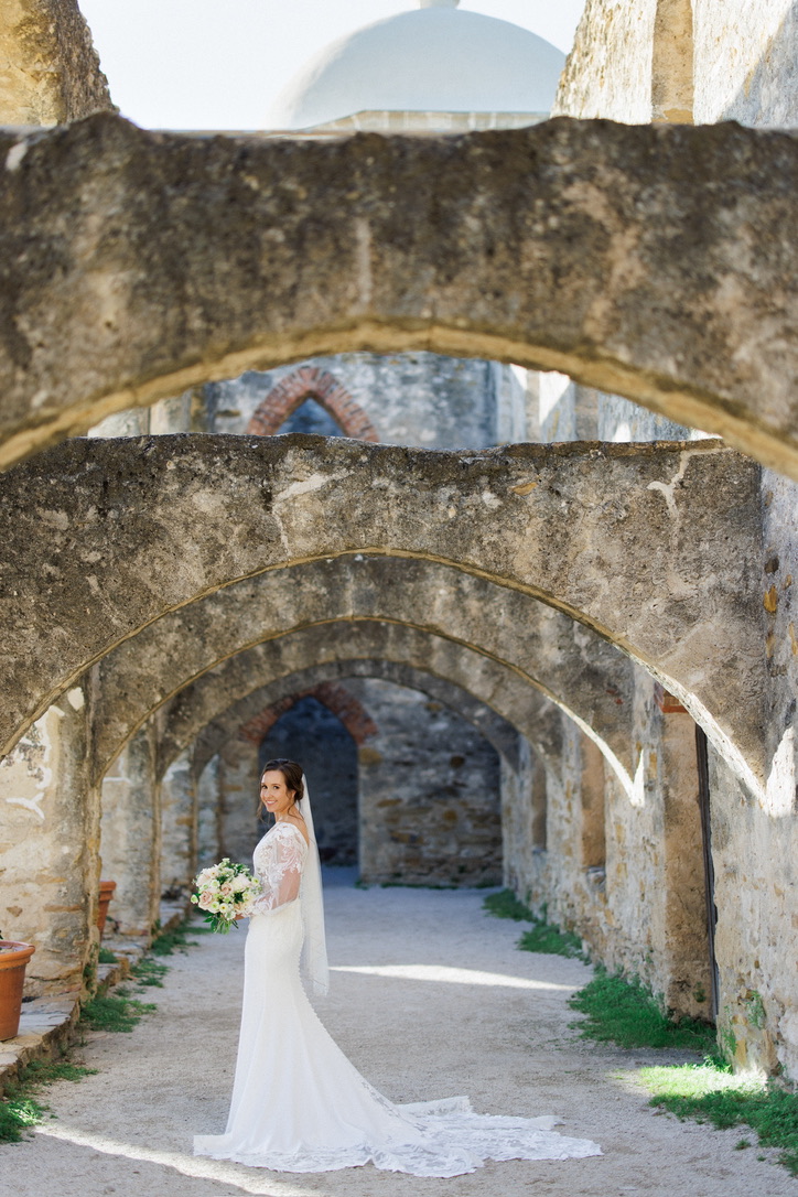 Beautiful bride taking her bridal portraits with Hill Country wedding planner Ashtyn of Lila Lane Events