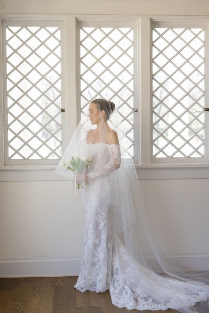 Gorgeous bridal portrait in front of architectural window, with Lila Lane Events