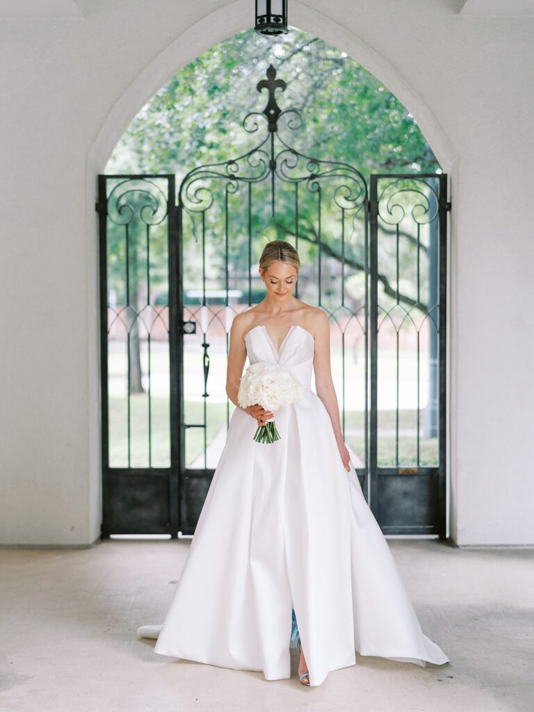 Bride holding a white bouquet during her bridal portraits in the Texas Hill Country, captured before her wedding day with planning support from a local wedding planner.