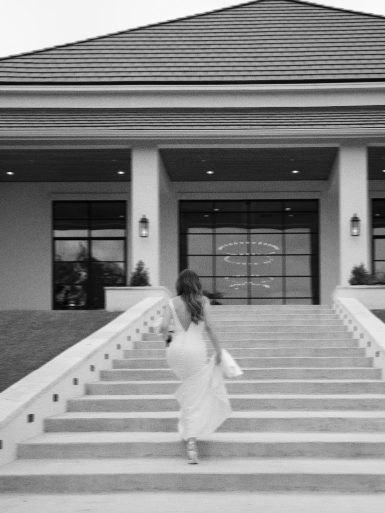Bride walking up steps at The Arlo, a minimalist Central Texas wedding venue.