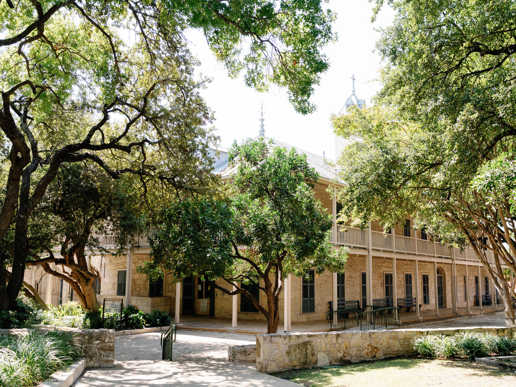 Historic building with wraparound porch at a Central Texas wedding venue, perfect for couples seeking Hill Country charm.