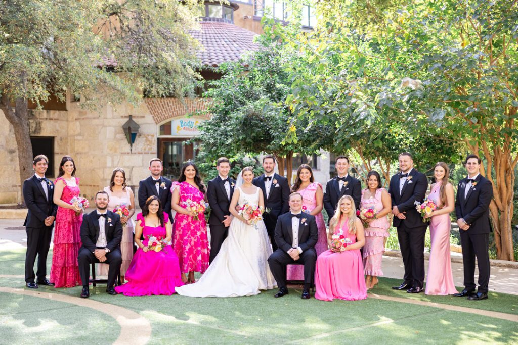 Wedding party group photo at a Central Texas wedding venue, with floral design and planning support.