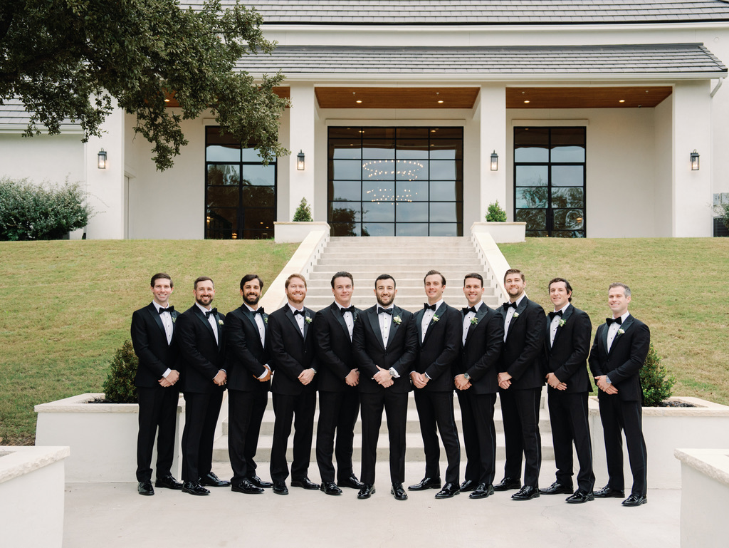 Groom and groomsmen in front of The Arlo, a Central Texas wedding venue known for its clean, modern design.