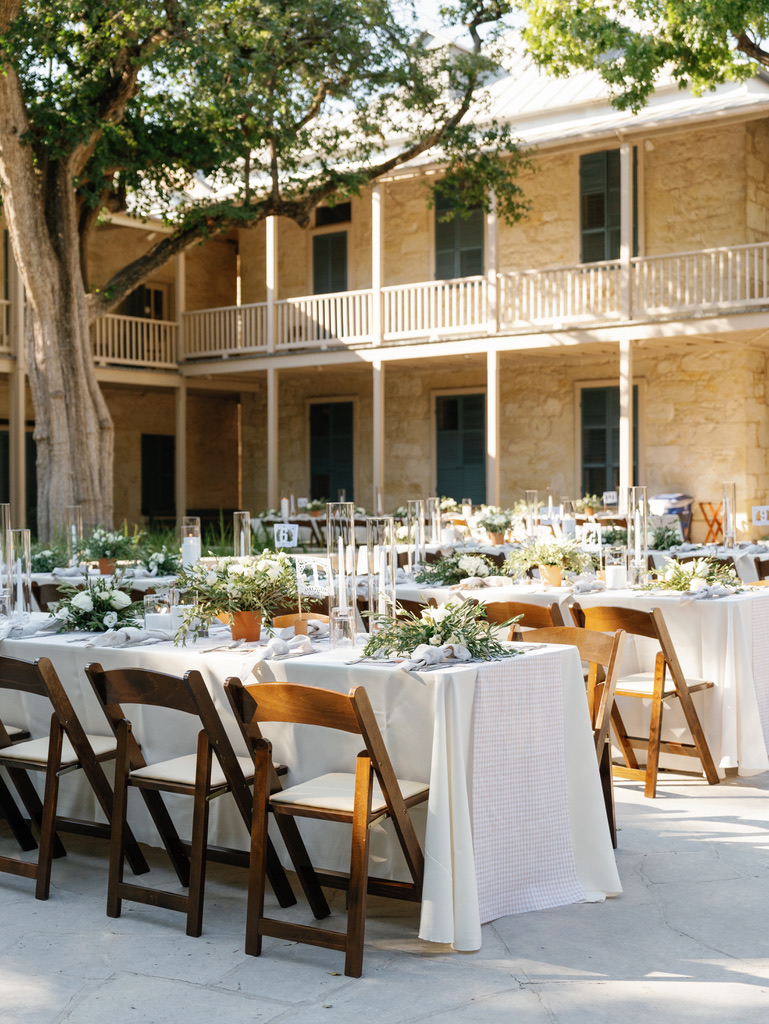 Outdoor reception tables with natural decor at a Central Texas wedding venue with historic architecture.