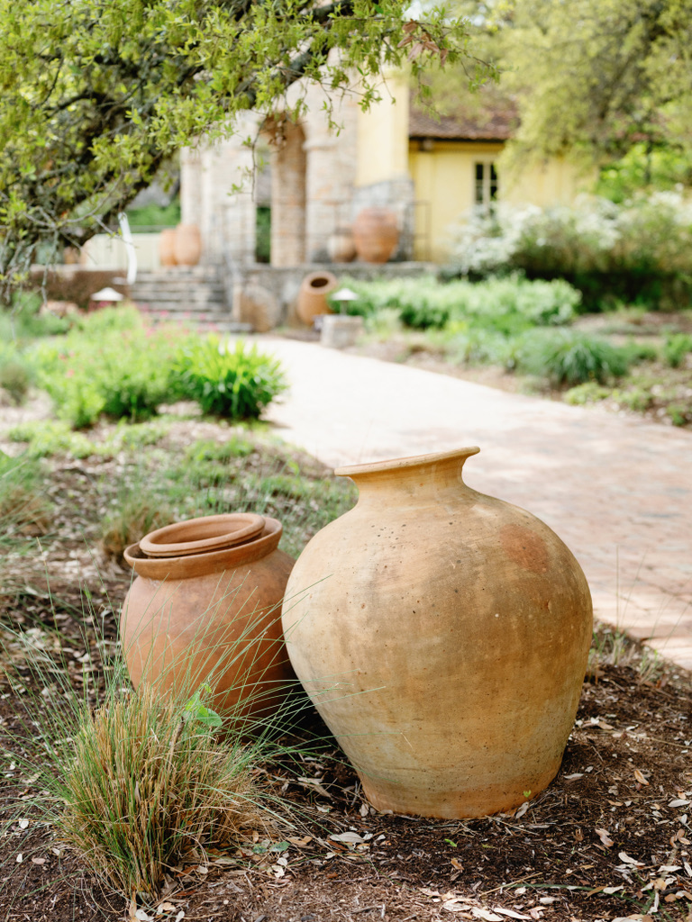 Terracotta pots and landscaping details at Camp Lucy, a Central Texas wedding venue blending rustic and elegant design.