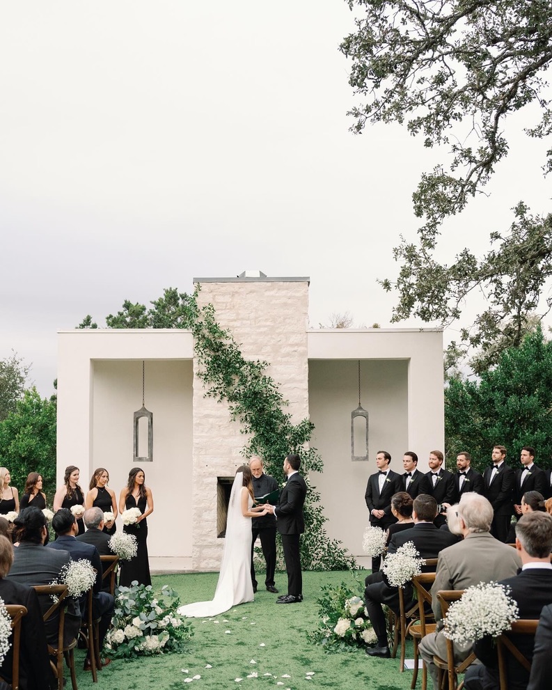 Outdoor wedding ceremony with modern backdrop at The Arlo, planned by a local wedding planner.