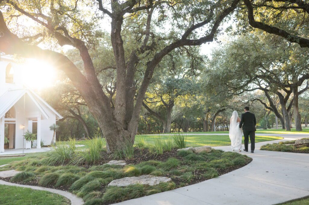 Scenic oak trees and landscaped grounds at The Chandelier of Gruene, a Hill Country wedding venue.