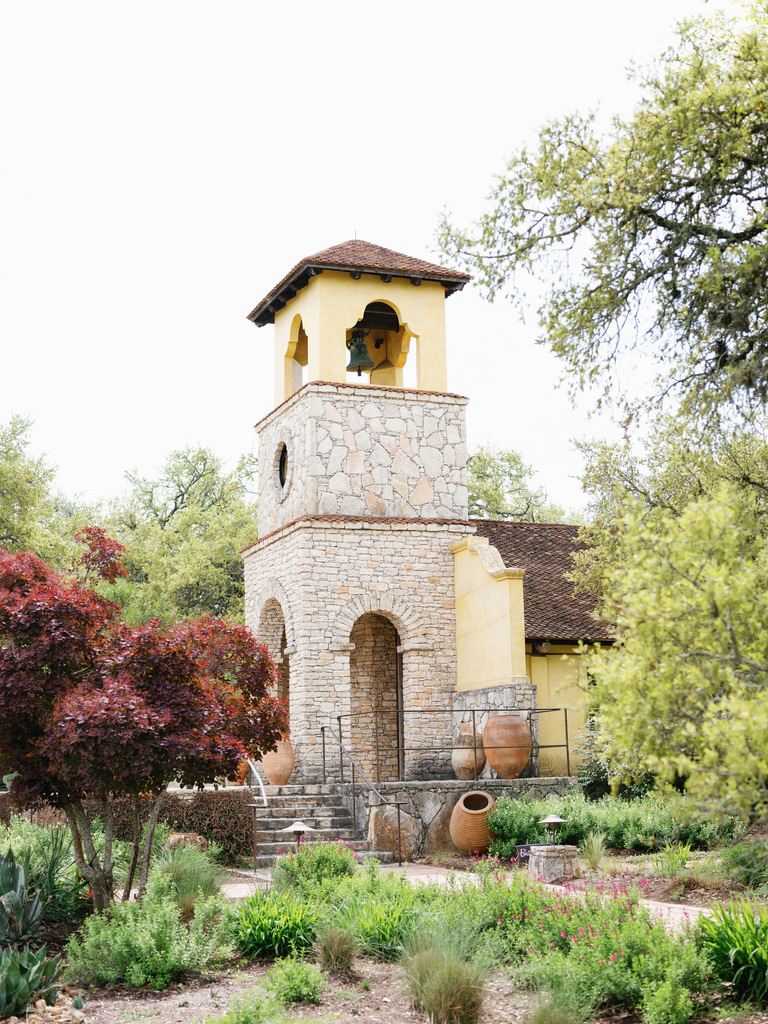 Stone chapel with terracotta accents at Camp Lucy, a Central Texas wedding venue known for Hill Country charm.