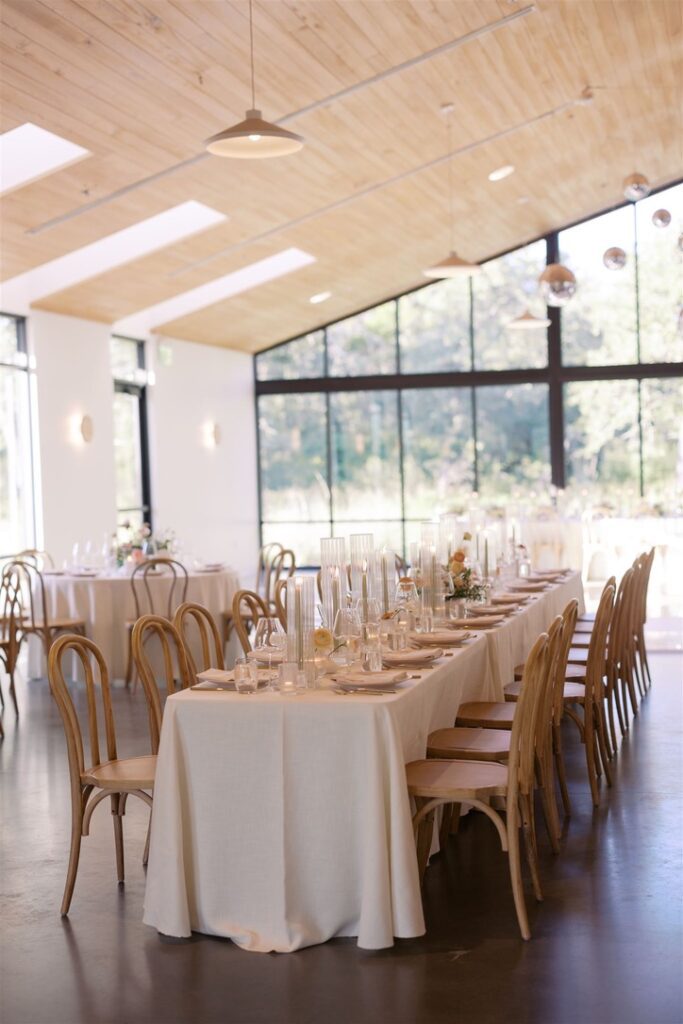 Reception tables in a bright, modern hall at The Grand Lady, a Central Texas wedding venue with natural light.
