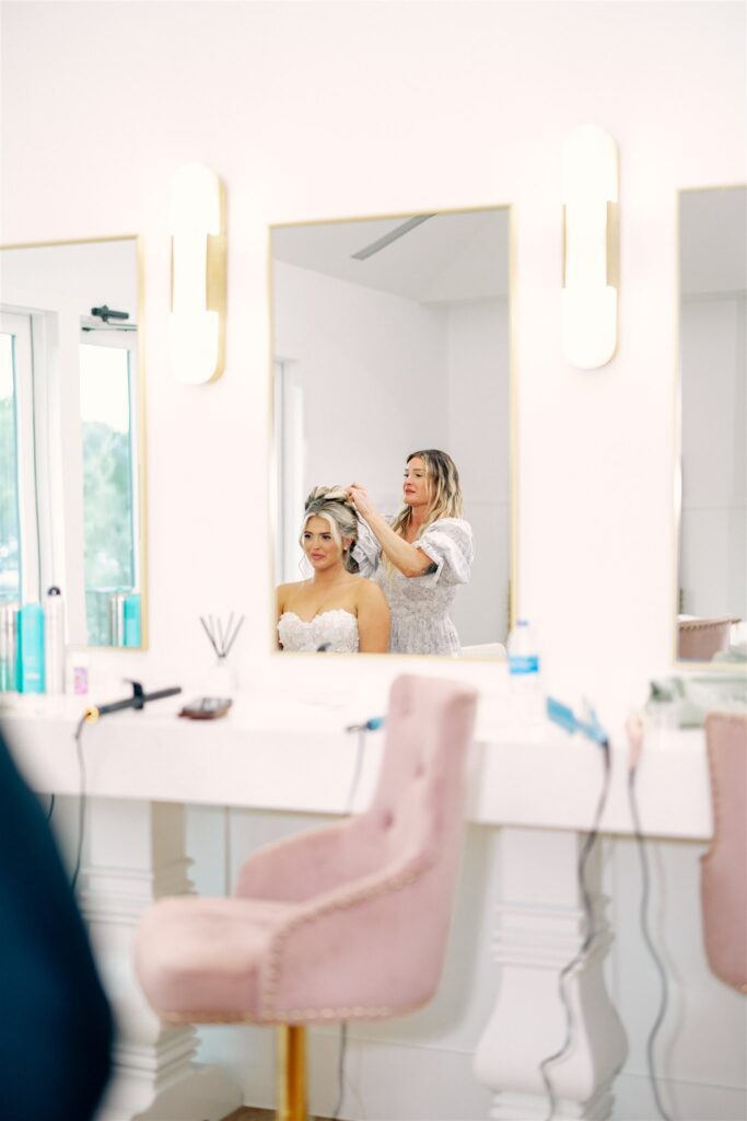 Bride getting her hair styled in elegant bridal suite | New Braunfels wedding planner timeline includes relaxed beauty time