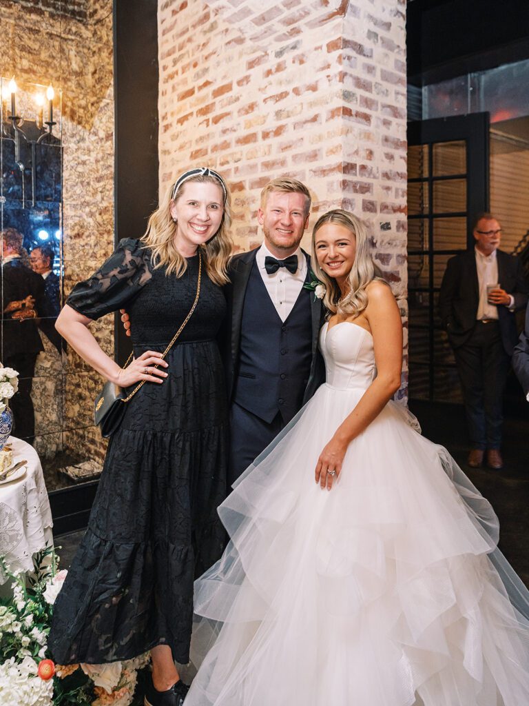 Central Texas wedding planner enjoying a sweet moment with the bride and groom on their wedding day
