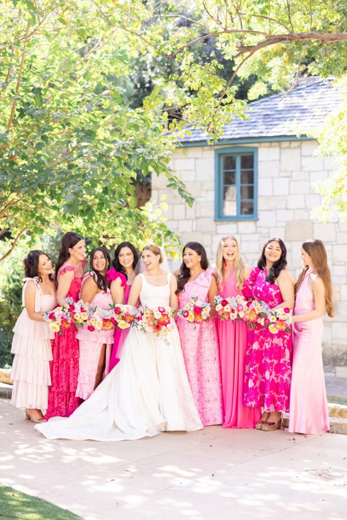 Bridal party in vibrant pink gowns with bold florals | Colorful wedding styled by New Braunfels wedding planner Lila Lane Events