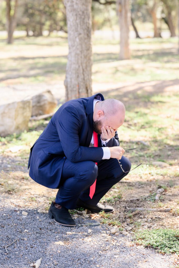 Groom crying tears of joy after seeing his bride for the first time on wedding day
