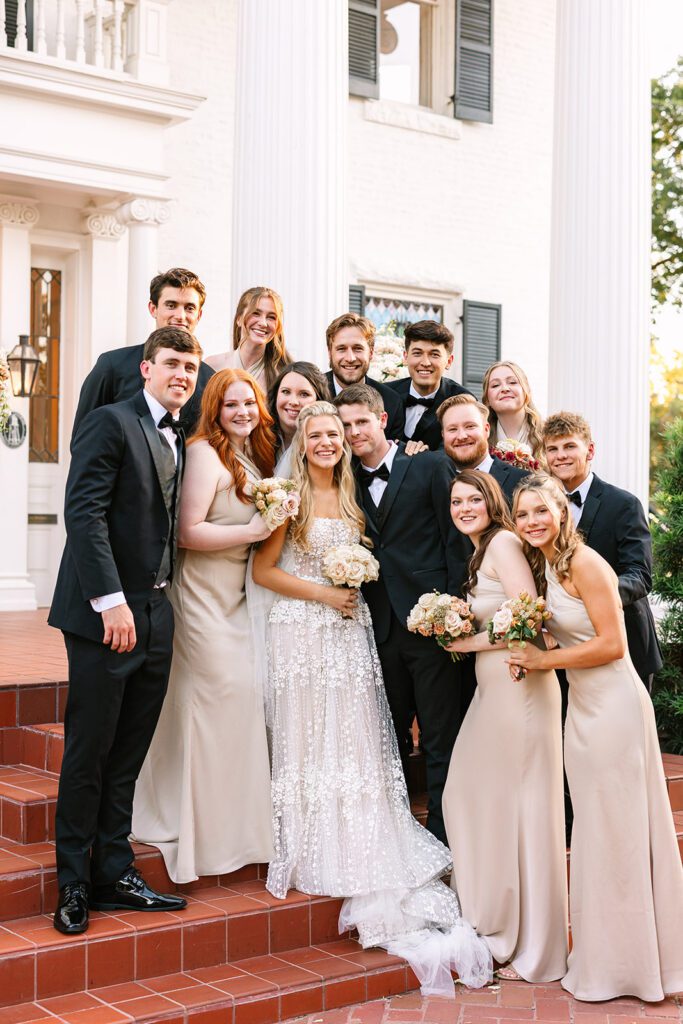 Bridesmaid and groomsmen surrounding this newlywed couple