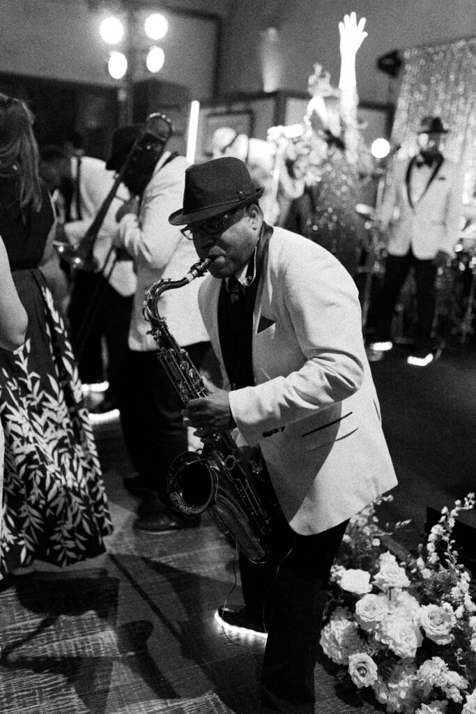 black and white photo of saxophone player at wedding reception