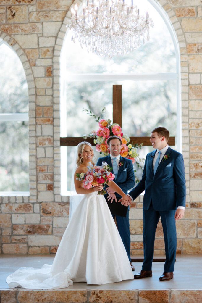 Bright pink florals at ceremony