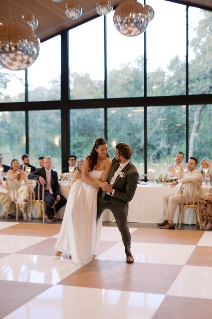 Couple sharing first dance under disco balls