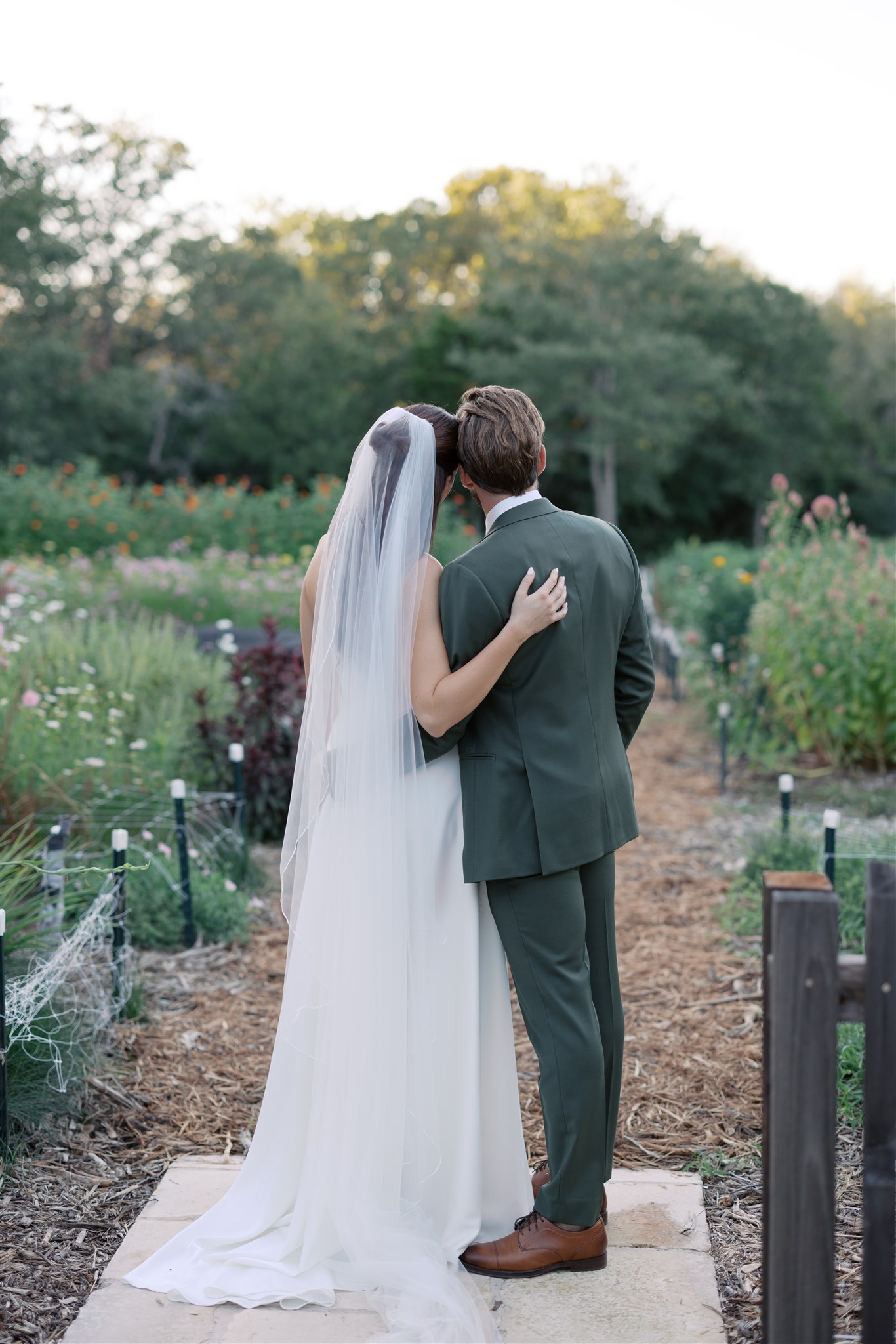 Newlyweds looking at flower garden