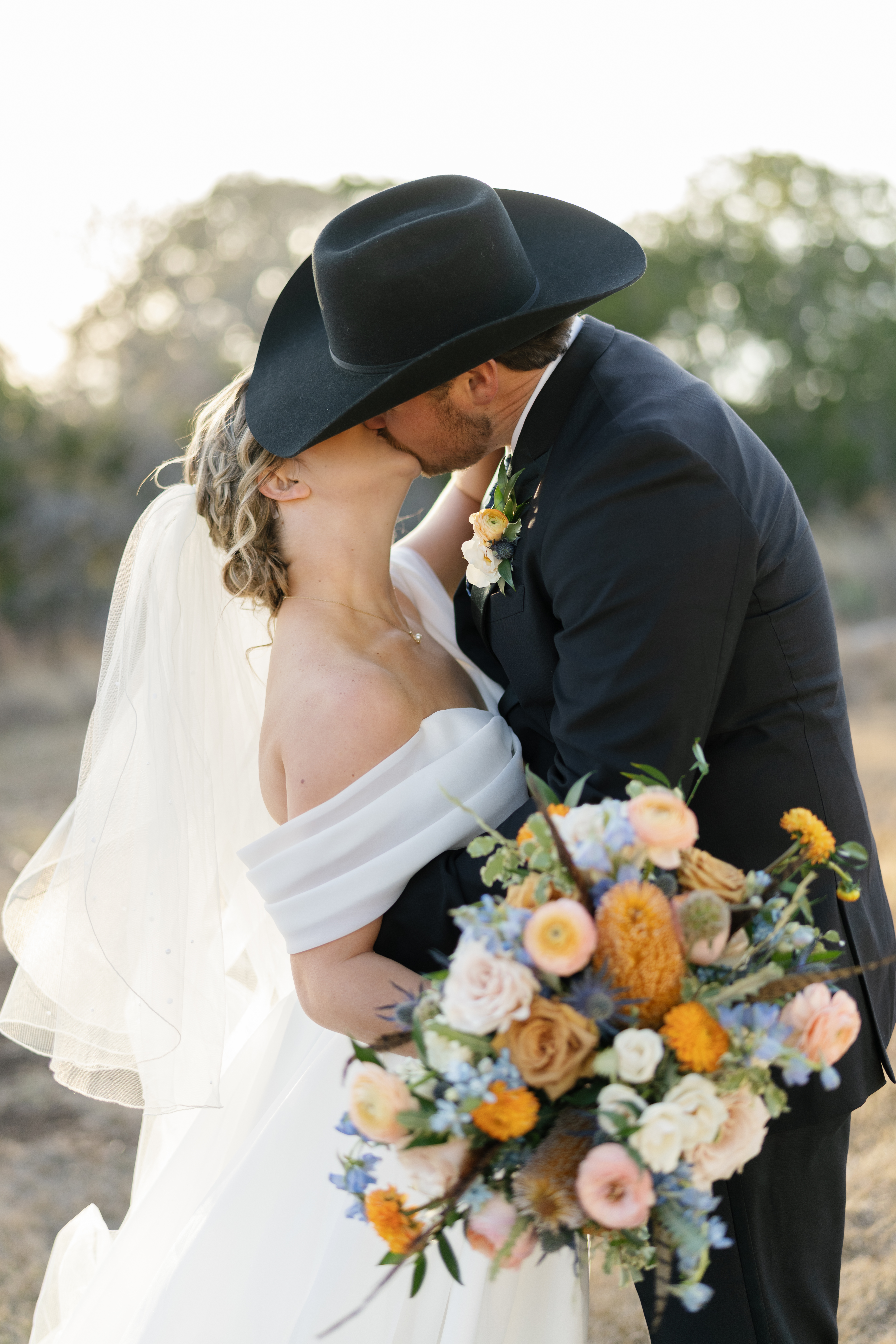 Newlyweds kissing at fall wedding