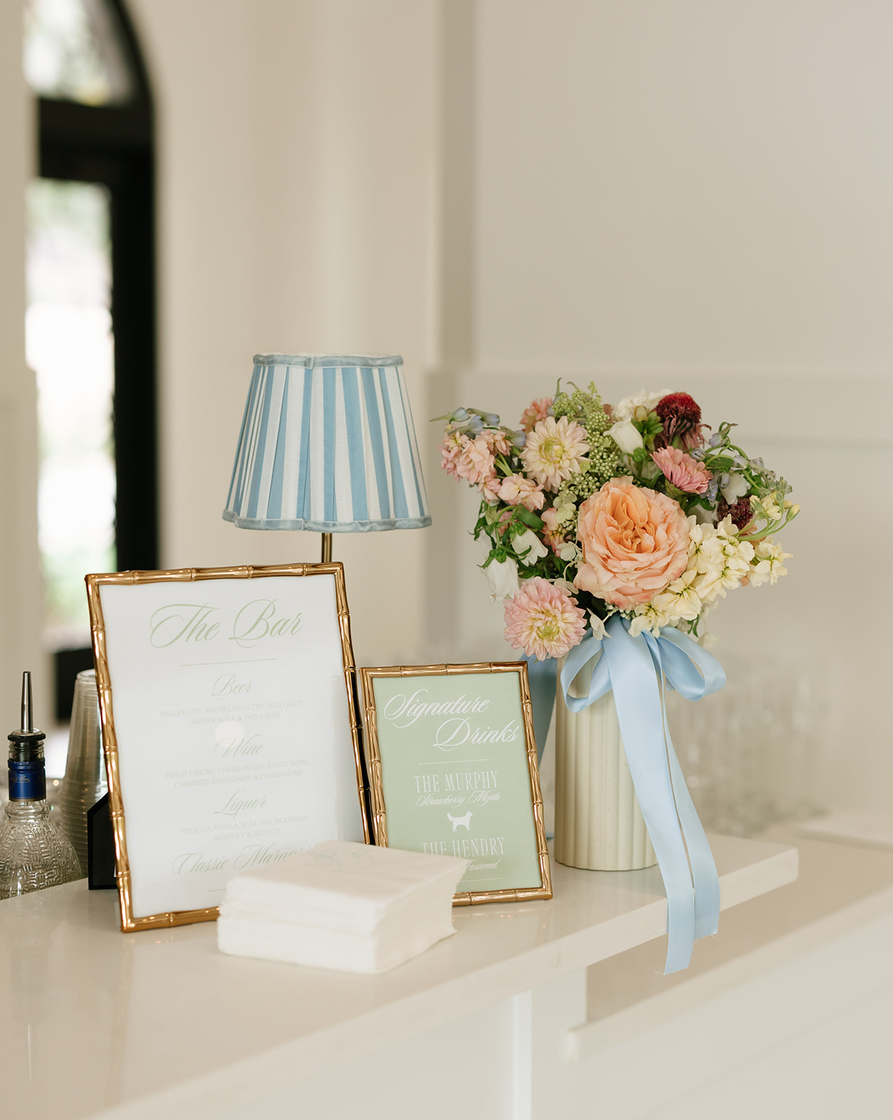 Wedding bar details with lamp and florals
